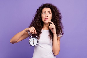 Women holding clock for time management